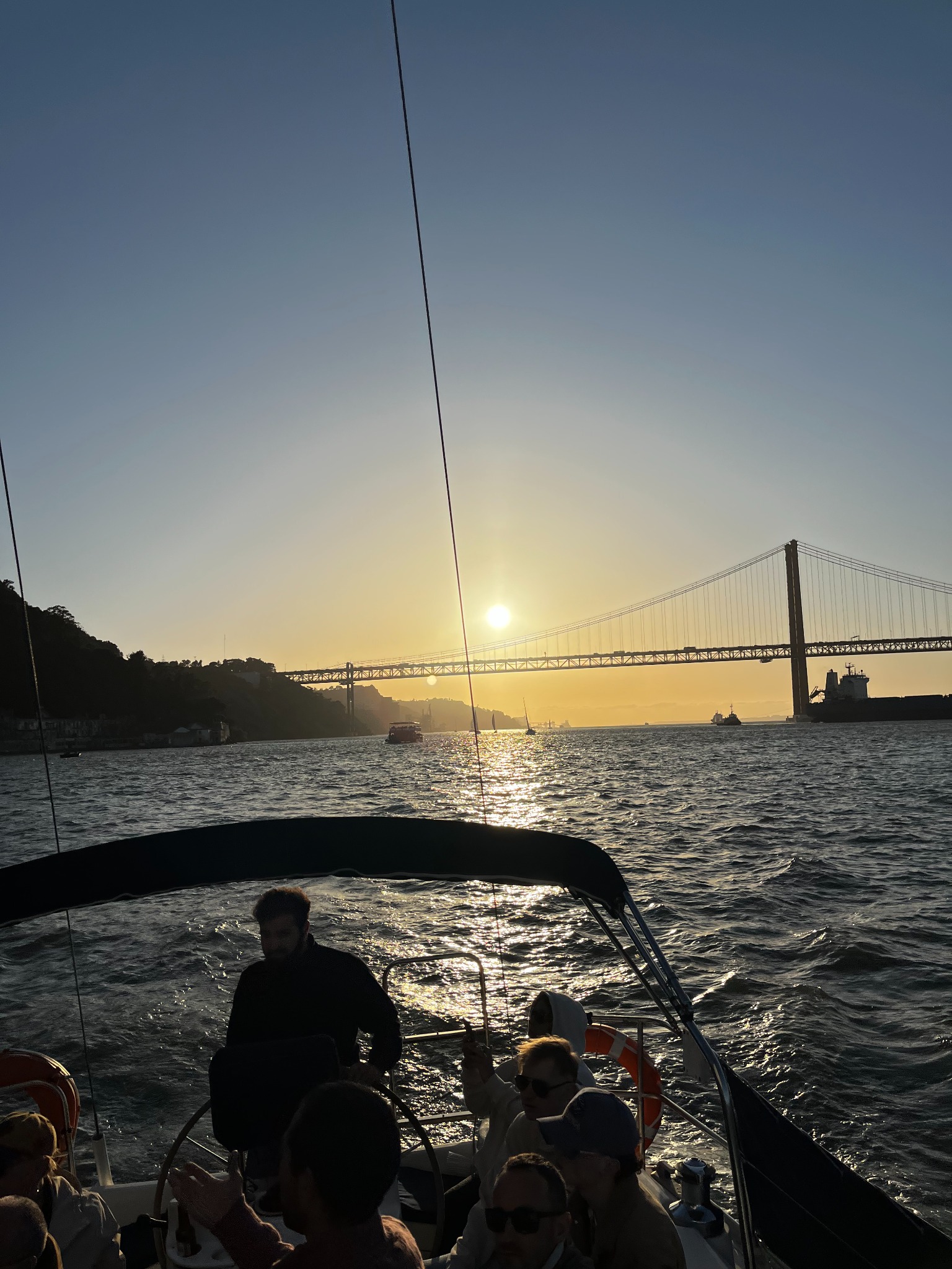 Sunset over the Tagus and the 25 de Abril Bridge, seen from our boat